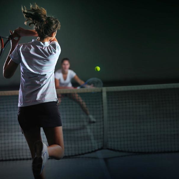 two women playing singles tennis at the Zenergy tennis courts